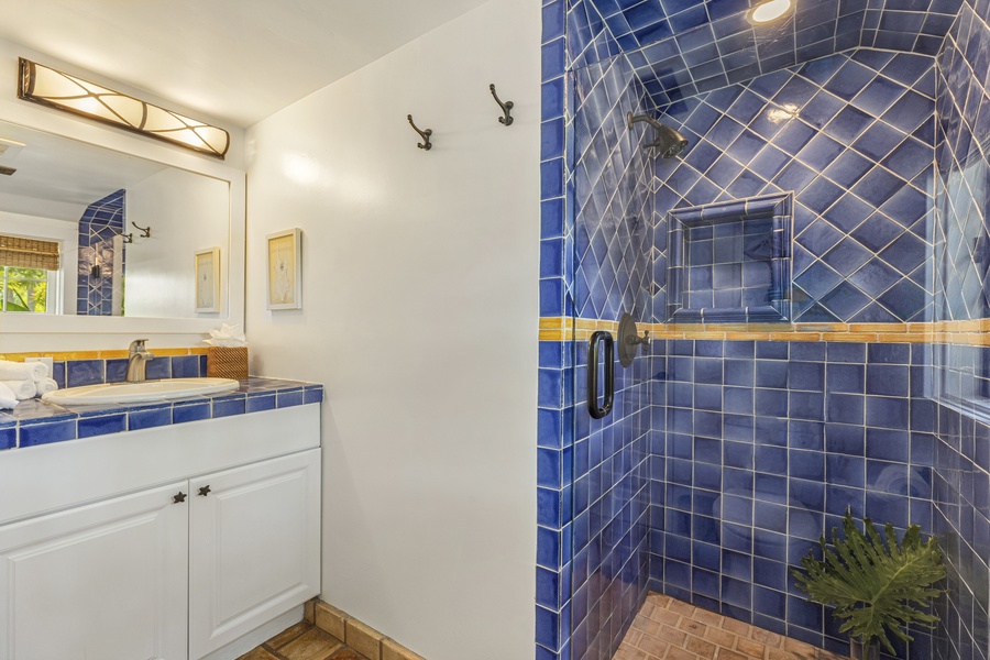 The pool cottage bathroom with a single vanity and a separate shower..