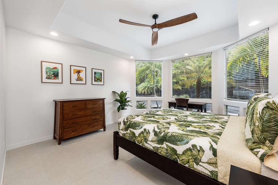 Cozy guest suite with leafy bedding and playful local art, great for families with kids or those seeking tucked-away comfort.