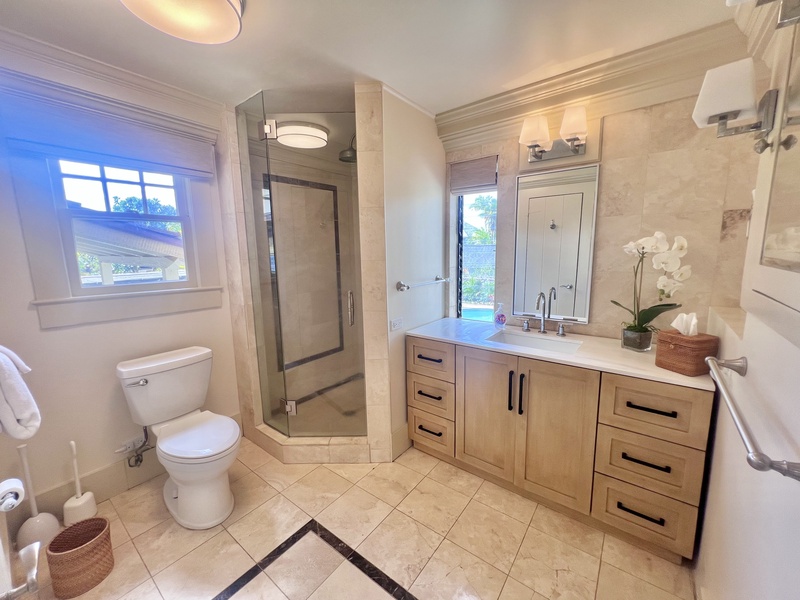 Modern bathroom with a walk-in shower, sleek vanity, and ample space for your morning routine.