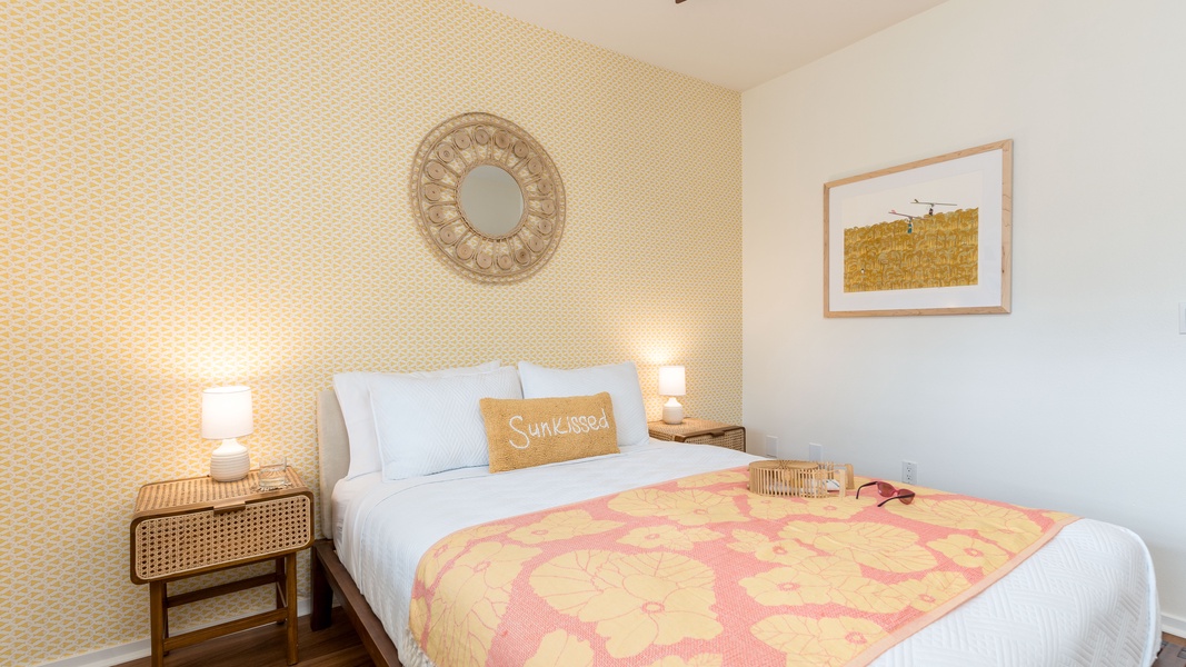 The second guest bedroom features subtle island prints and delicate lighting.