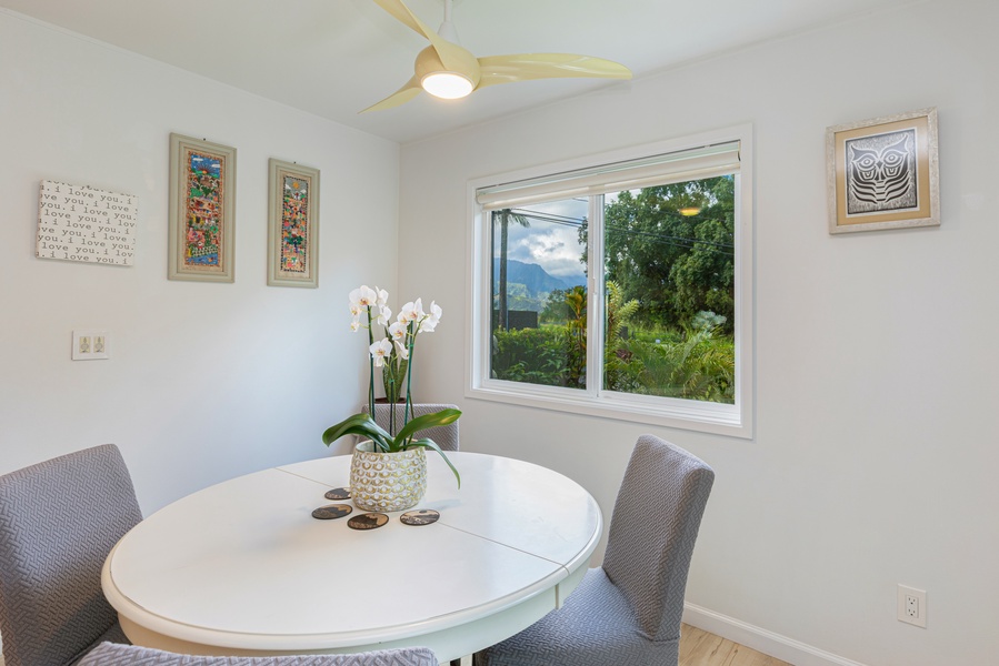 Cozy dining area with seating for four, natural light and peaceful garden views.