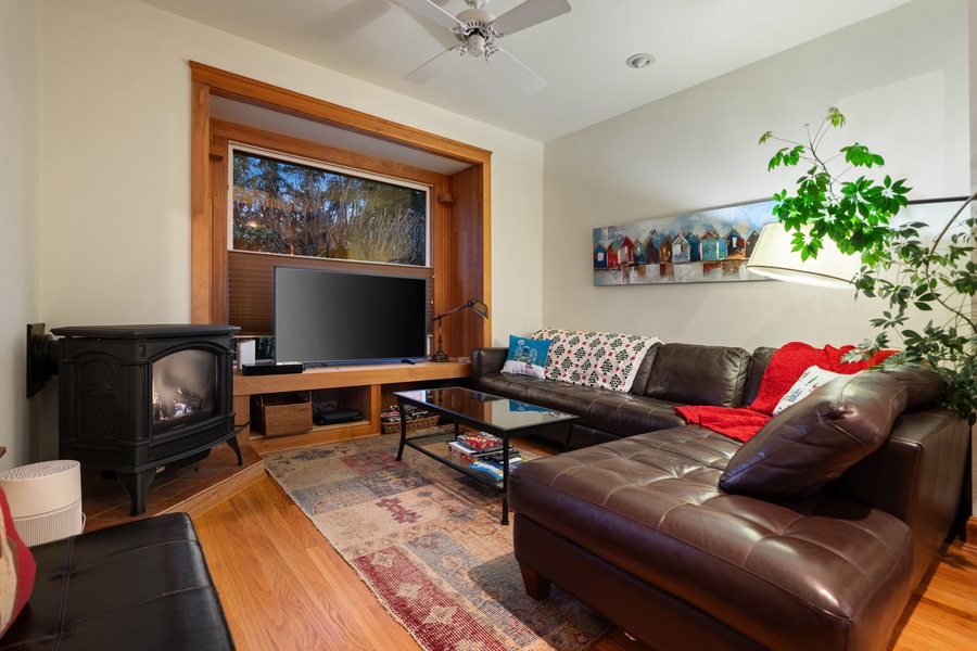 Cozy and festive living space featuring a warm fireplace and holiday accents.