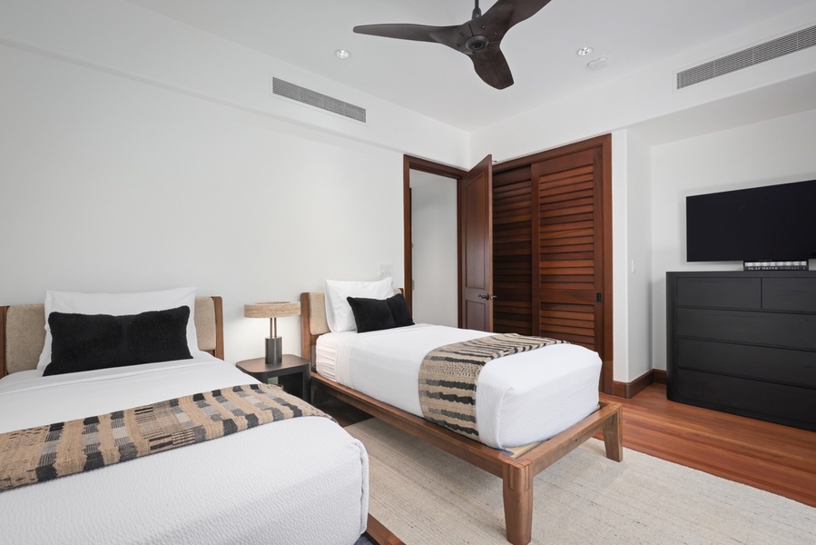 Second bedroom (lower level) with two twin size beds (king conversion upon request) and Smart TV with adjacent full bath.