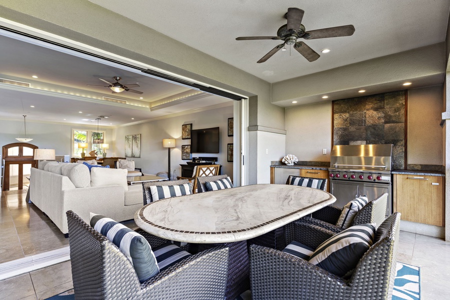 Wailea Hoolei 93-3 offers seamless indoor-outdoor living with a spacious lanai, dining area, and cozy seating.