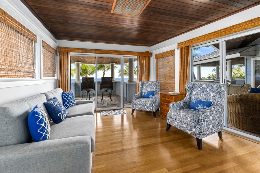 Ocean-facing lanai with two bar stools, perfect for morning coffee or sunset views.