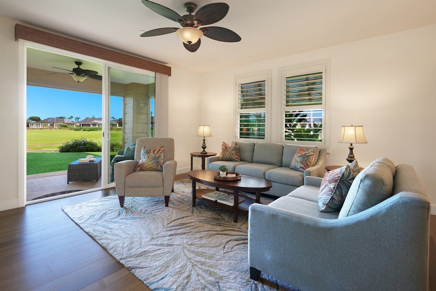 Relax in your elegantly furnished living room, where tropical ceiling fans keep you cool and sliding doors open to stunning golf course views.