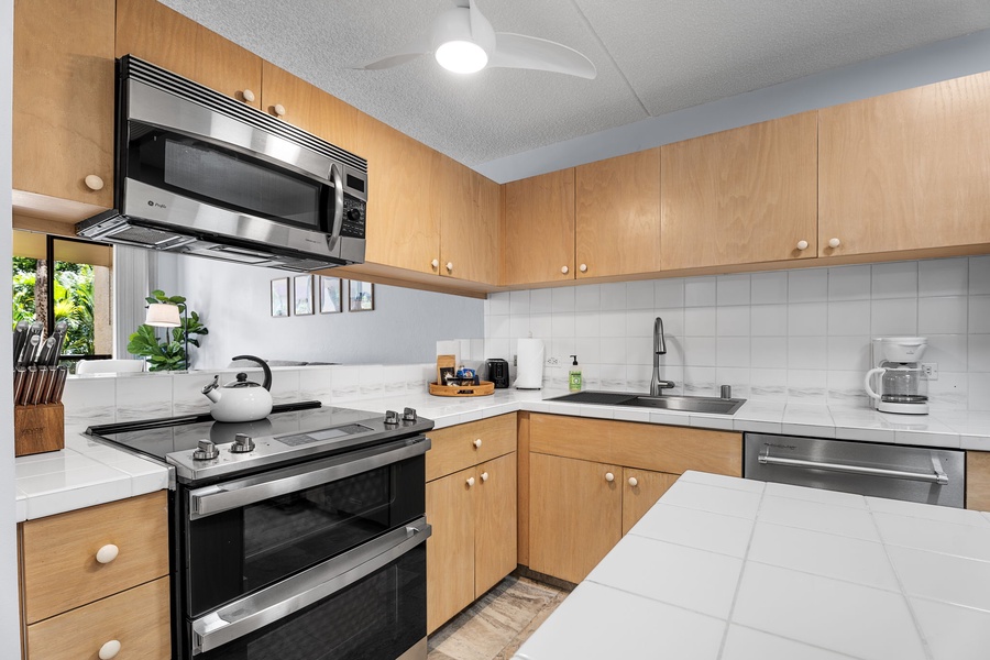 Fully equipped kitchen with wooden cabinetry and modern appliances.