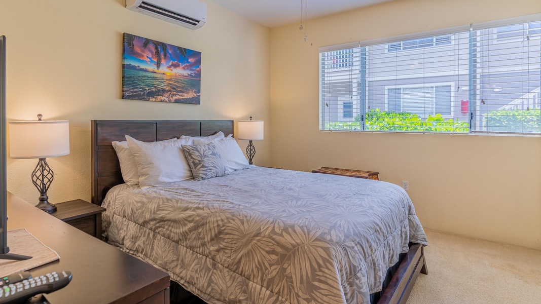 The primary guest bedroom has a TV, space to unwind and a large closet.