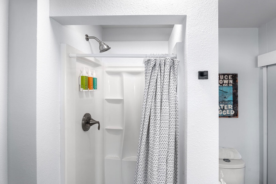 Shared bathroom with walk-in shower and simple island-inspired touches.