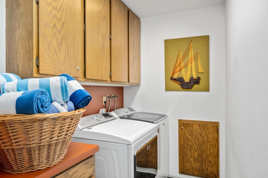 A private laundry space with a washer and a dryer right off the primary