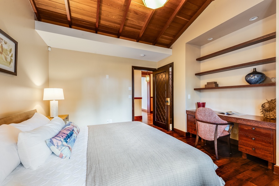 Elegant bedroom with built-in desk and shelving — perfect for work-from-paradise stays.