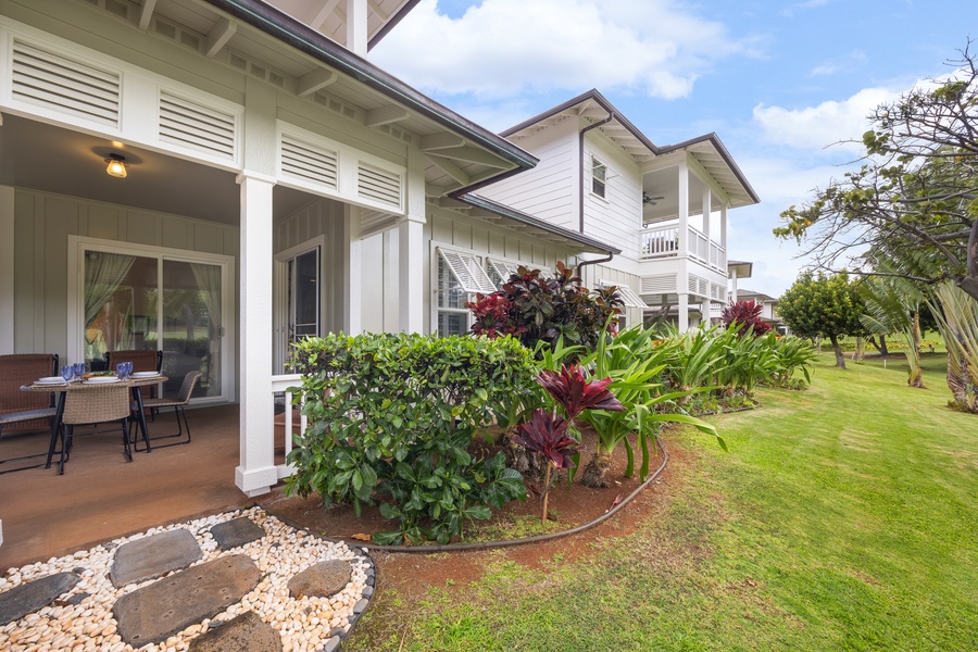 Tropical property with lush landscaping and covered patio area surrounded by vibrant island vegetation.