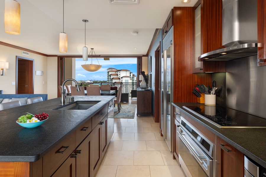 Your gourmet kitchen features premium appliances and sleek countertops, opening to stunning ocean views that make cooking feel like a luxury retreat.