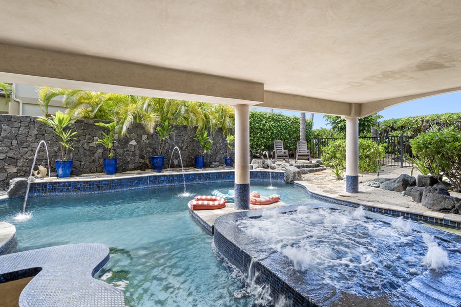 Private pool with shaded lounging and in-pool seating—swim, float, or relax in total comfort.