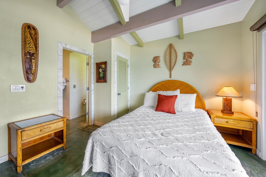 Rest comfortably in this bright bedroom with vaulted ceilings and soft island breezes from the nearby lanai.