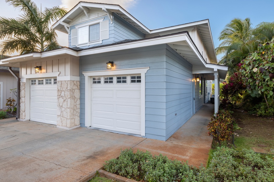 Elegant coastal home with tropical landscaping and convenient garage parking in a serene residential setting.