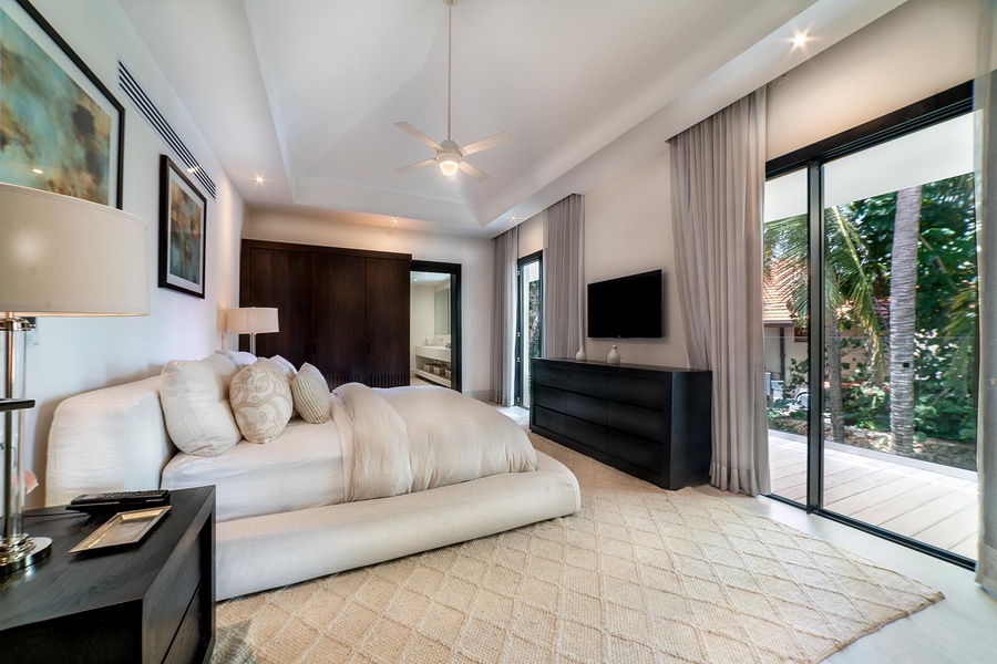 Retreat to this sophisticated bedroom with a king-size bed and direct access to a private patio.