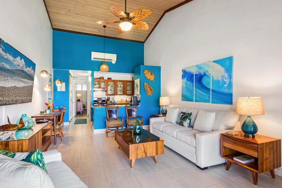 Bright and airy, this living area offers a seamless flow into the kitchen, with vibrant decor that adds a splash of tropical flair.