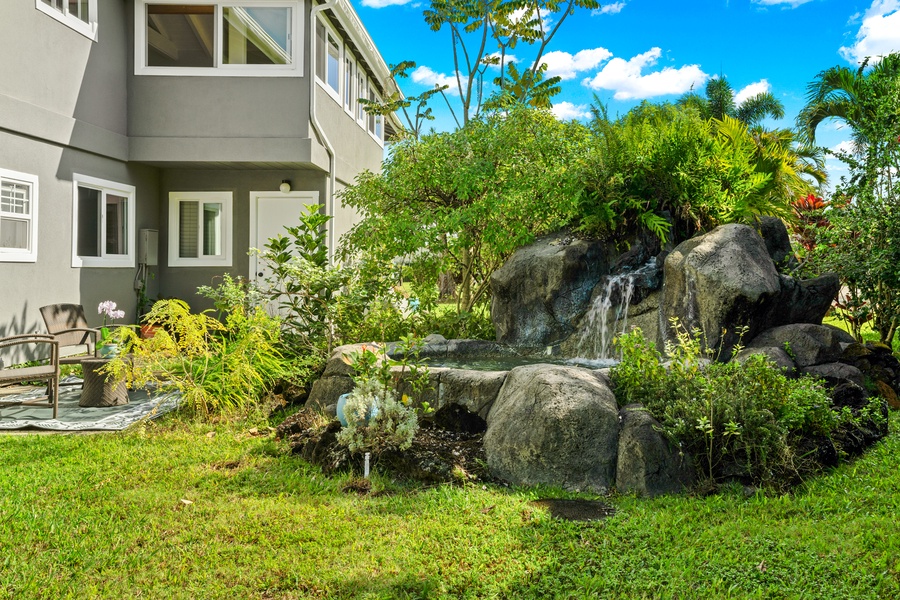 Beautifully maintained garden area with lush foliage and natural rock accents, creating a private oasis.