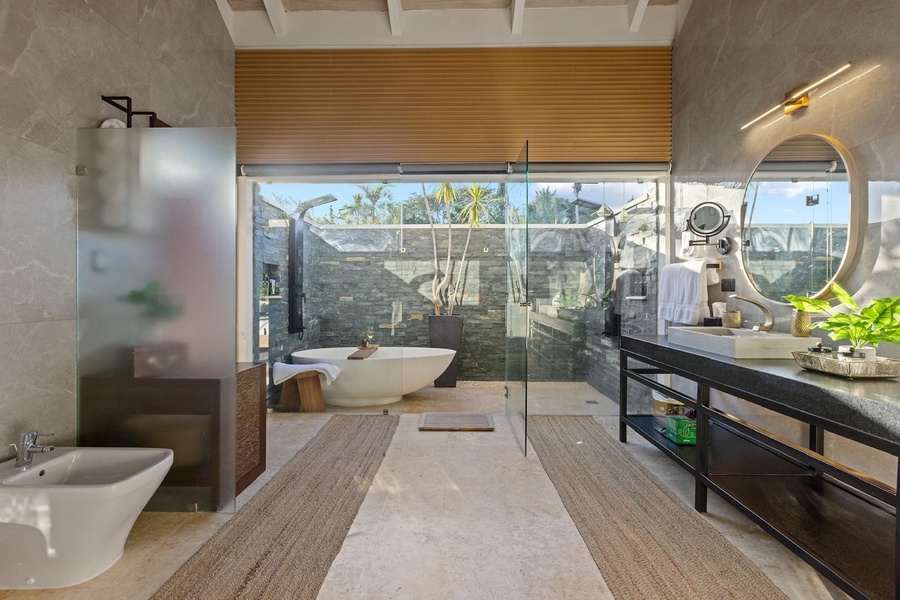 Luxurious primary bathroom with a freestanding tub, double vanity, and indoor-outdoor shower.