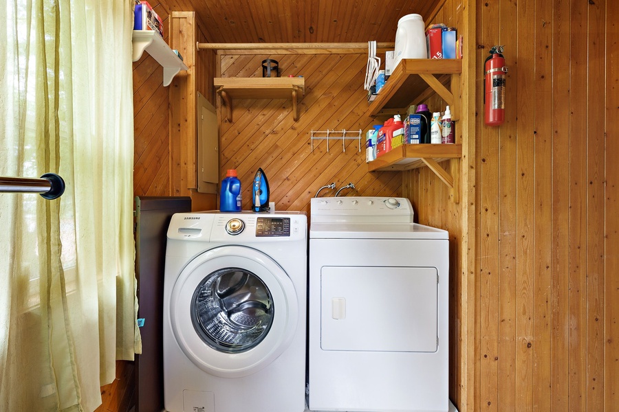 Simplify your vacation with a washer, dryer, and organized shelves in this well-equipped laundry space.