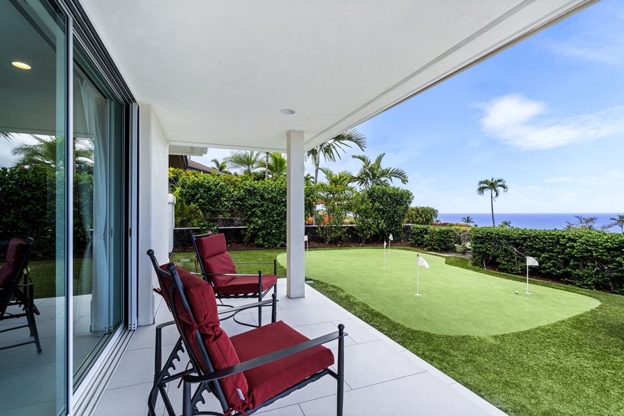 Relax on the shaded lanai overlooking the putting green and lush landscaping.