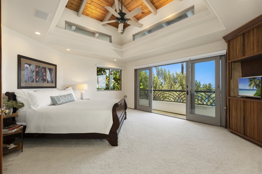 The Primary Bedroom is furnished with an Olympic queen bed, access to the ocean front lanai, walk-in closet, and ensuite bath