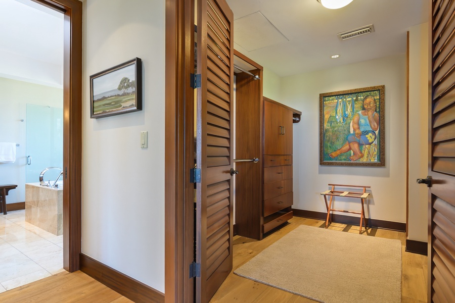 Step into your tropical retreat where warm wood accents and thoughtful artwork create an inviting entrance to your private sanctuary.