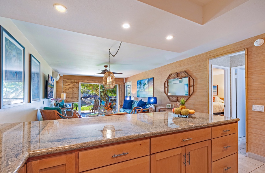 The kitchen island opens to the bright living area, allowing for easy conversation and a seamless flow between cooking and entertaining.