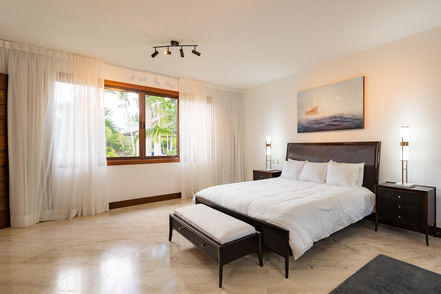 Enjoy the beautiful garden views seen from the large windows of the guest bedroom.