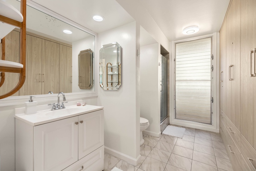 Ensuite bathroom with ample vanity and a walk-in shower