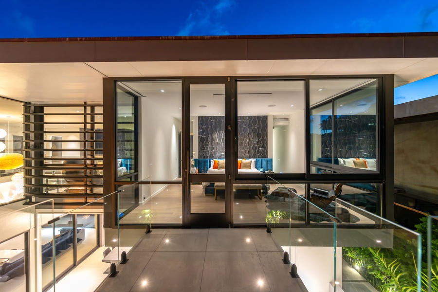 Glass-paneled bridges and custom lighting create an unforgettable sense of arrival for every guest.