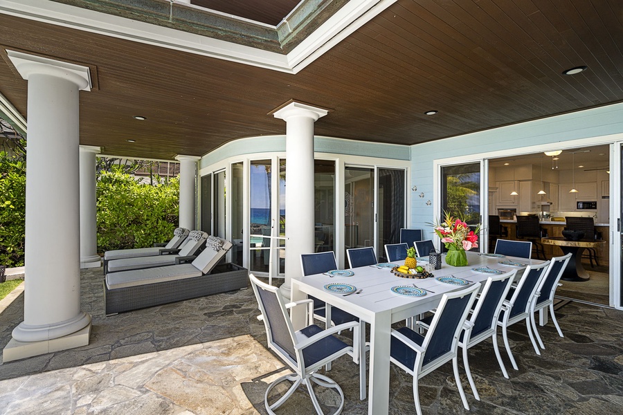 Alfresco dining setup with ample seating and lush tropical ambiance.