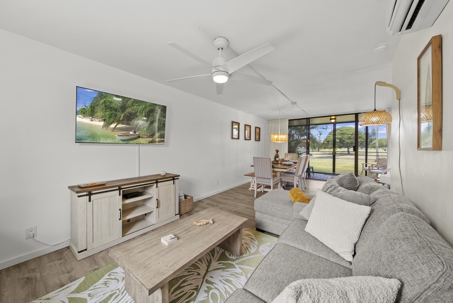 Downstairs living room with queen sleeper sofa, sitting area and outdoor screened lanai.