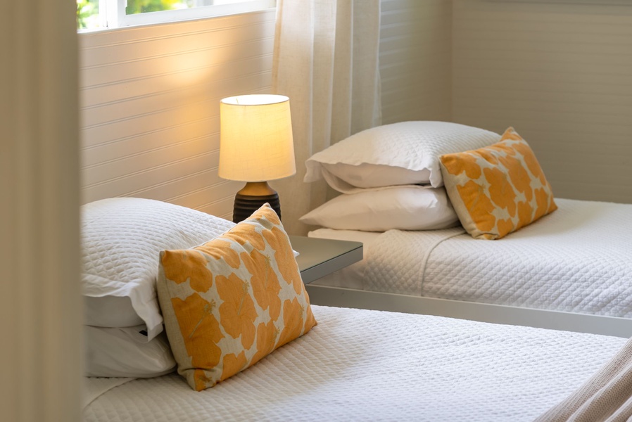 Your cozy bedroom with two comfortable beds, soft pillows, and a warm bedside lamp creates the perfect spot to rest after a day of exploring.