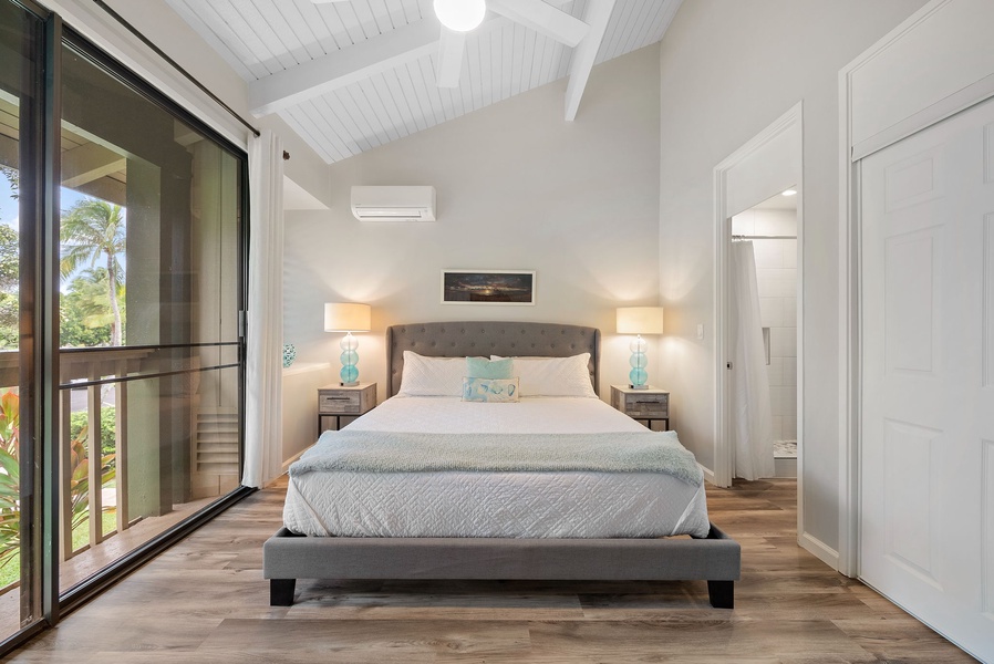 Primary bedroom with a view and ensuite bathroom.