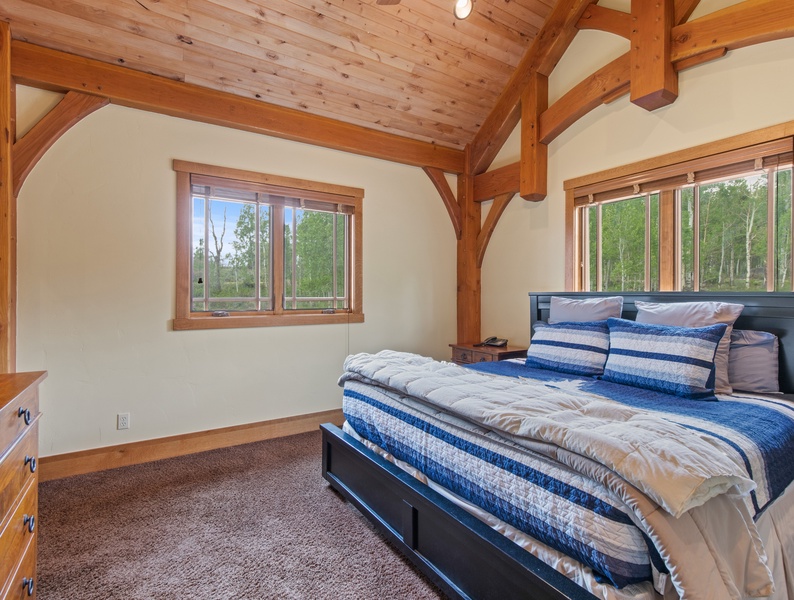 Tranquil relaxation in the master bed with scenic views outside window walls