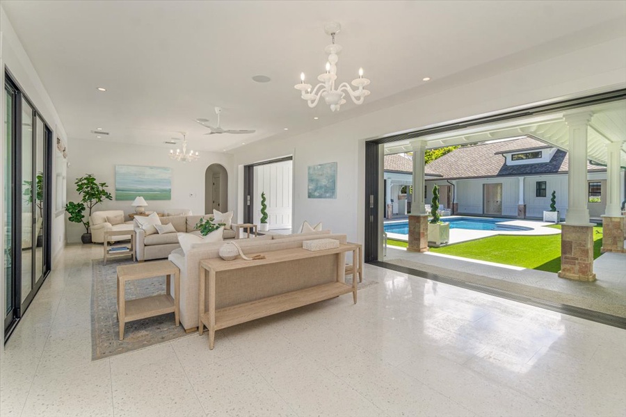 Grand great room with vaulted ceilings, designer lighting, and seamless indoor‑outdoor flow.