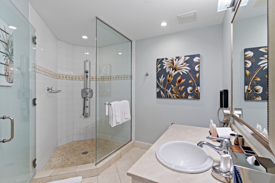 The ensuite bath in this bedroom at Wailea Hoolei 93-3 features a separate shower and single vanity.