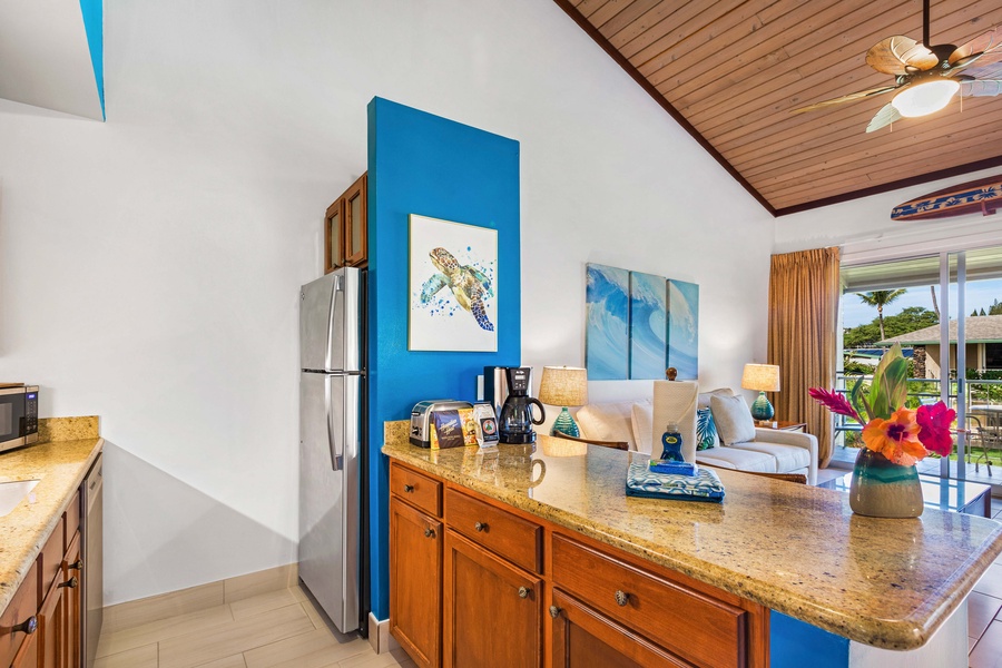 Bright and colorful kitchen with modern appliances and an open layout, perfect for preparing meals while enjoying the lively atmosphere of the living area.