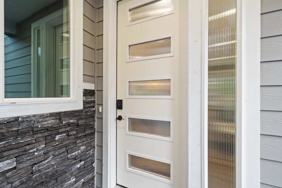 Contemporary design featuring stone accents and glass panels.