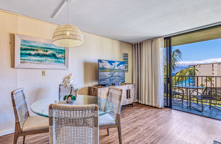 The dining area flows into the living room, with access to the lanai for easy indoor-outdoor living.