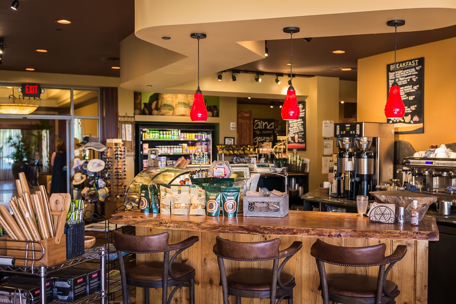 This cozy café offers a warm and inviting atmosphere with a variety of snacks and beverages displayed behind the counter.