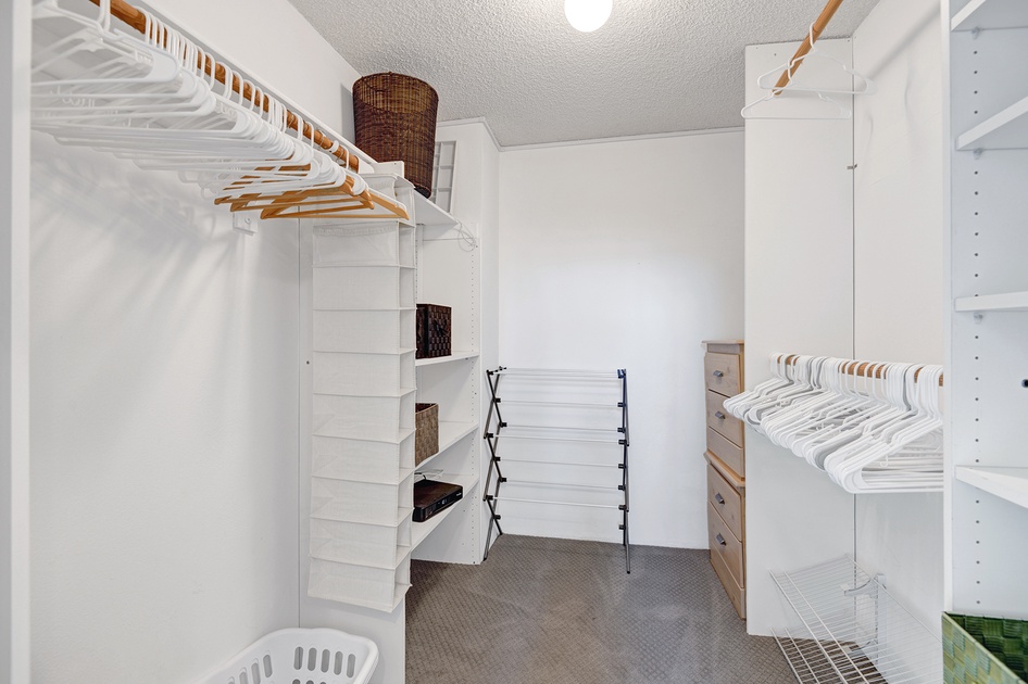 Primary bedroom walk in closet