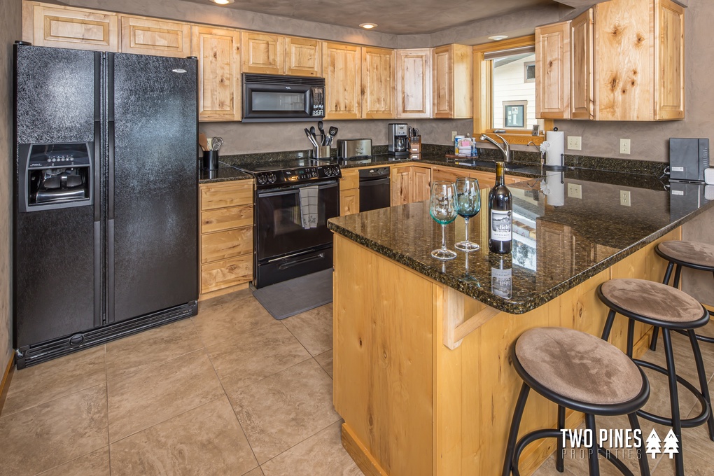 Fully Stocked Kitchen With Bar Seating