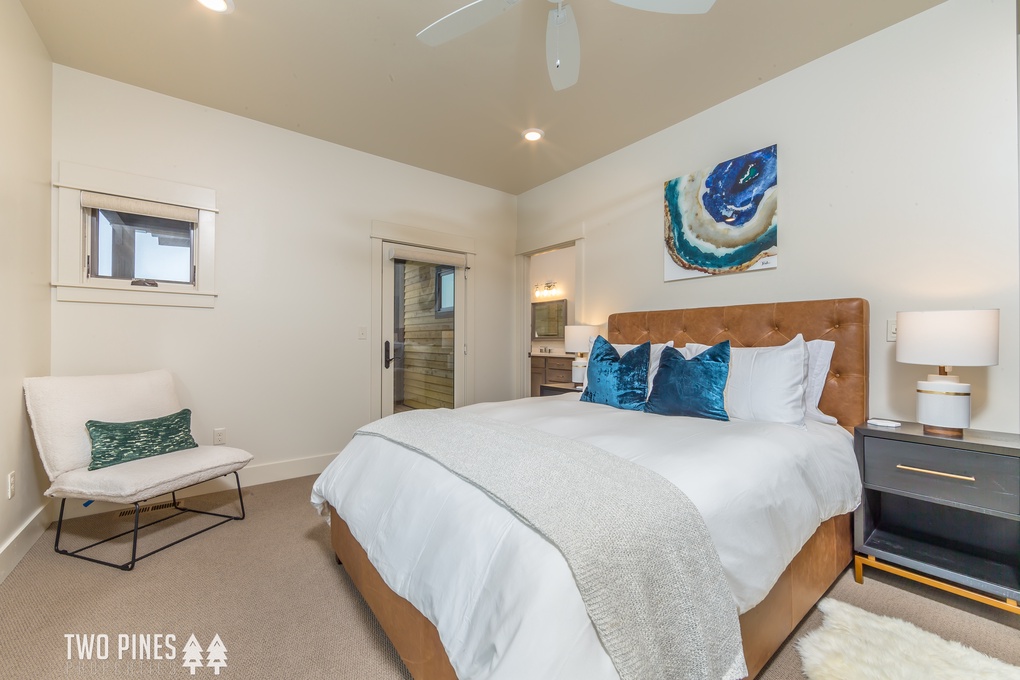 1st Guest Bedroom- Queen bedroom with en suite, TV, and private deck