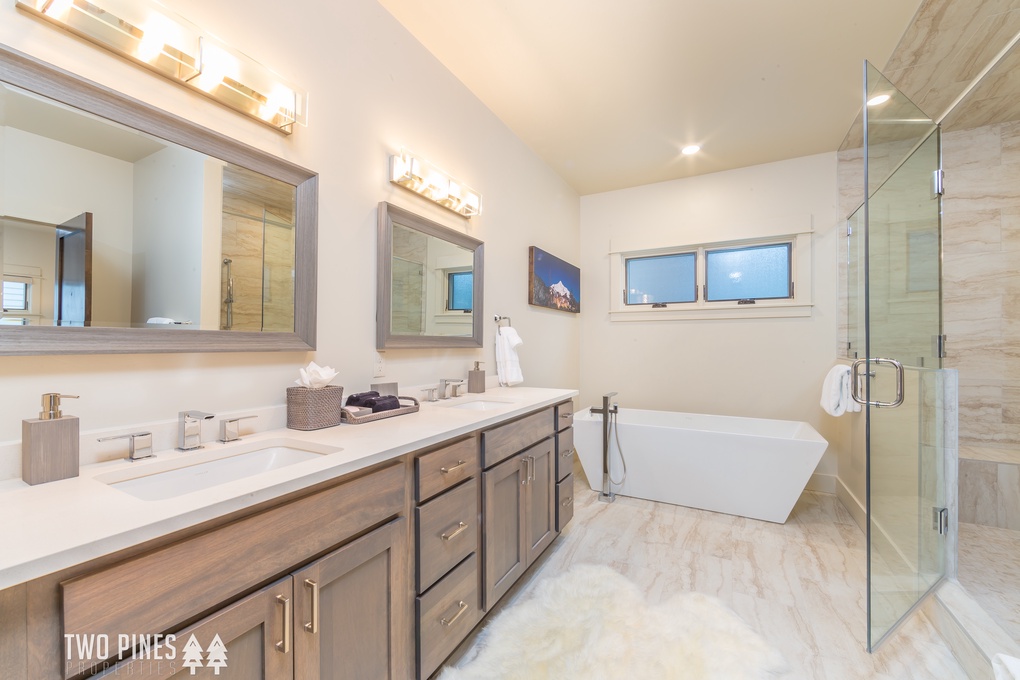 Primary En Suite with double vanity, soaking tub, and walk-in shower