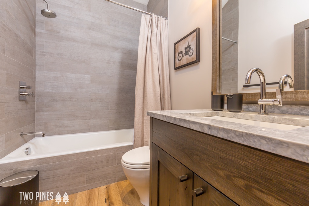 Upstairs Bunkroom En Suite with a Single Vanity and Shower/Tub Combo