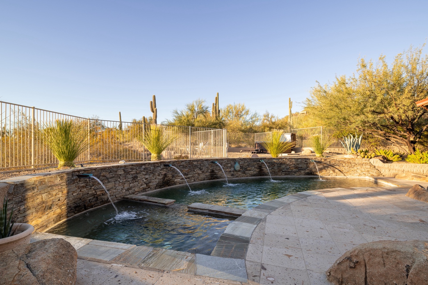 Serene pool with spacious in-ground hot tub