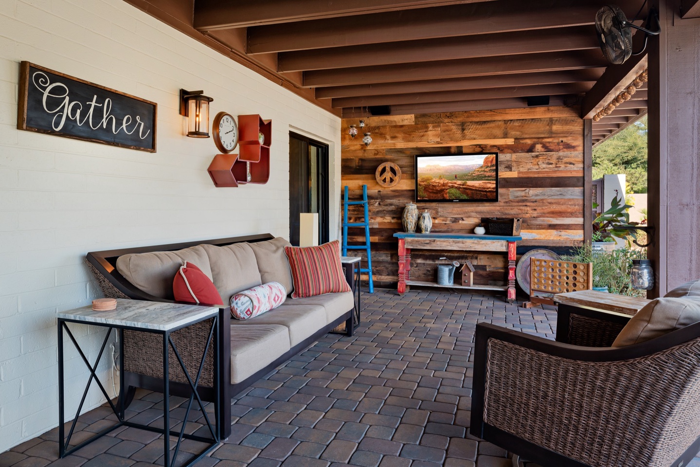 Outdoor living area with wall TV & surround sound
